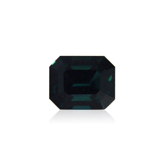 Le Saphir Teal de Bonnot Paris est une pierre précieuse taille émeraude vert foncé de 4,04 carats avec une surface facettée qui reflète magnifiquement la lumière, mise en valeur sur un fond blanc.