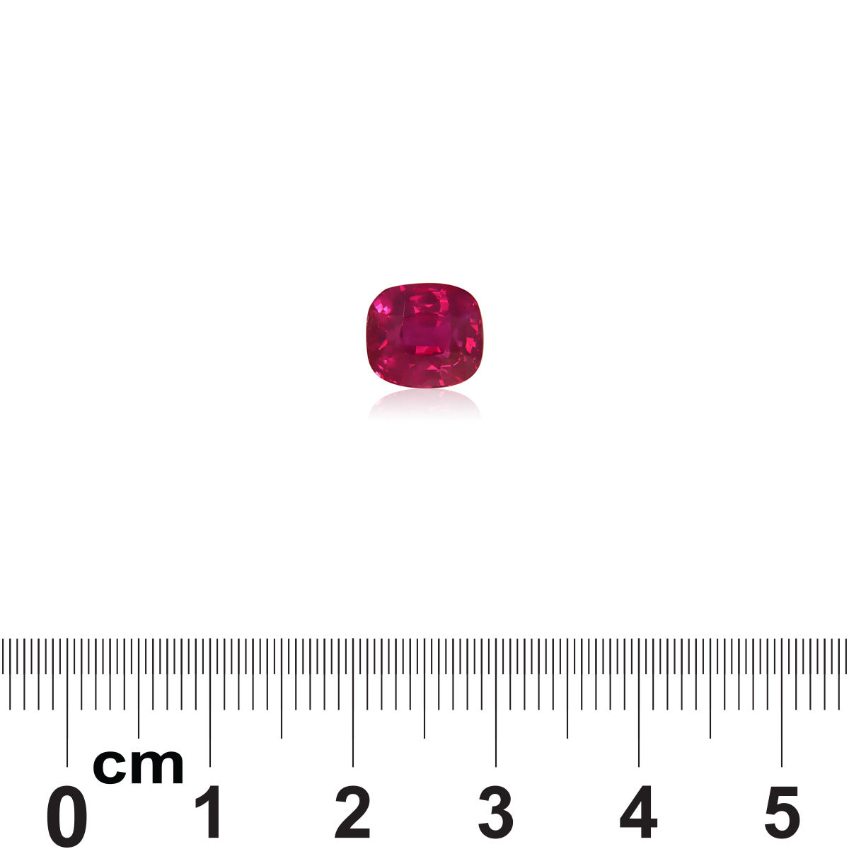 Le Saphir Rose, une pierre précieuse rose vif de Bonnot Paris pesant 3,02 ct, est placé sur une surface blanche à côté d'une règle graduée en centimètres pour comparer la taille.